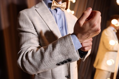 Photo of Man getting ready near mirror indoors, closeup