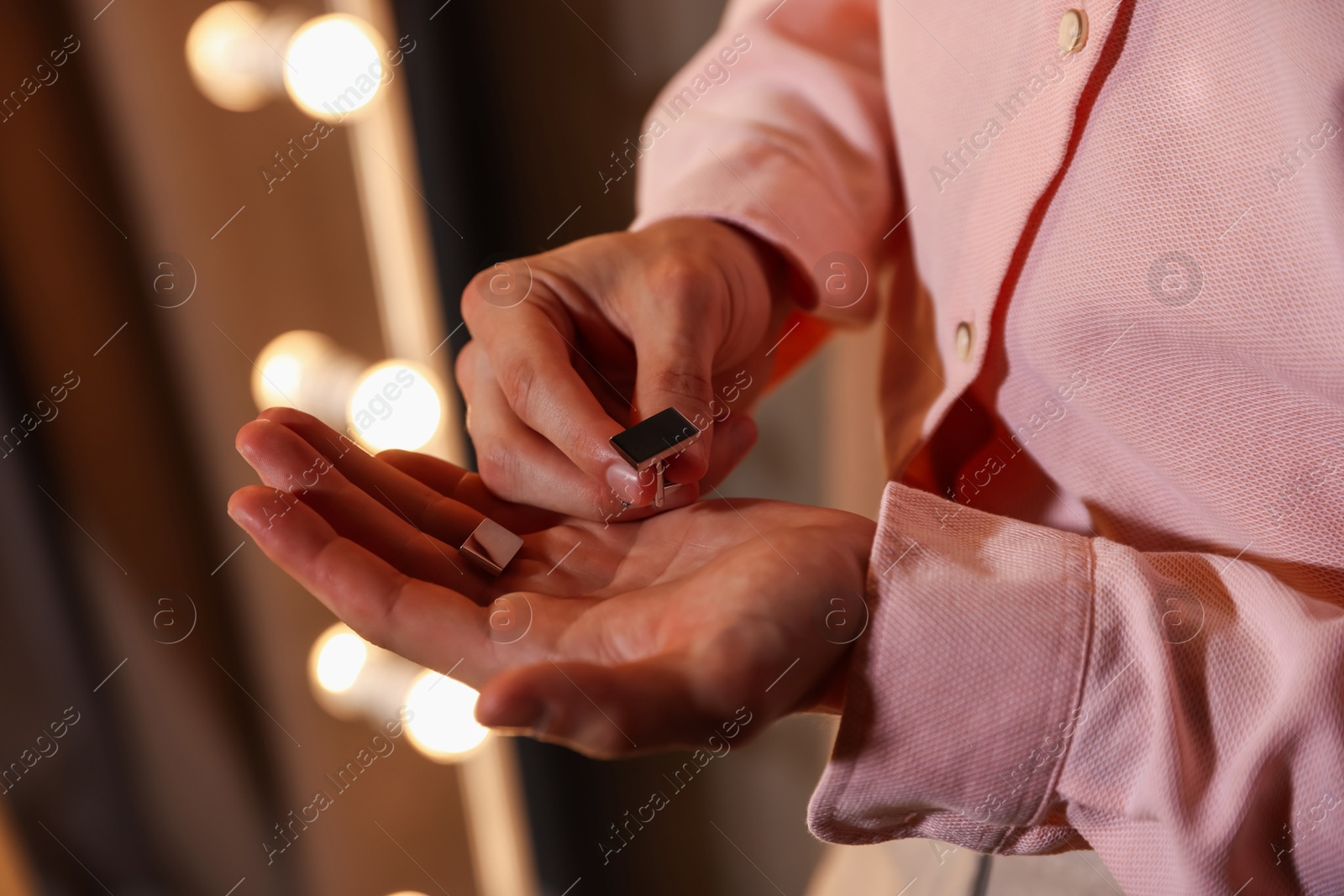 Photo of Man with cufflinks getting ready indoors, closeup