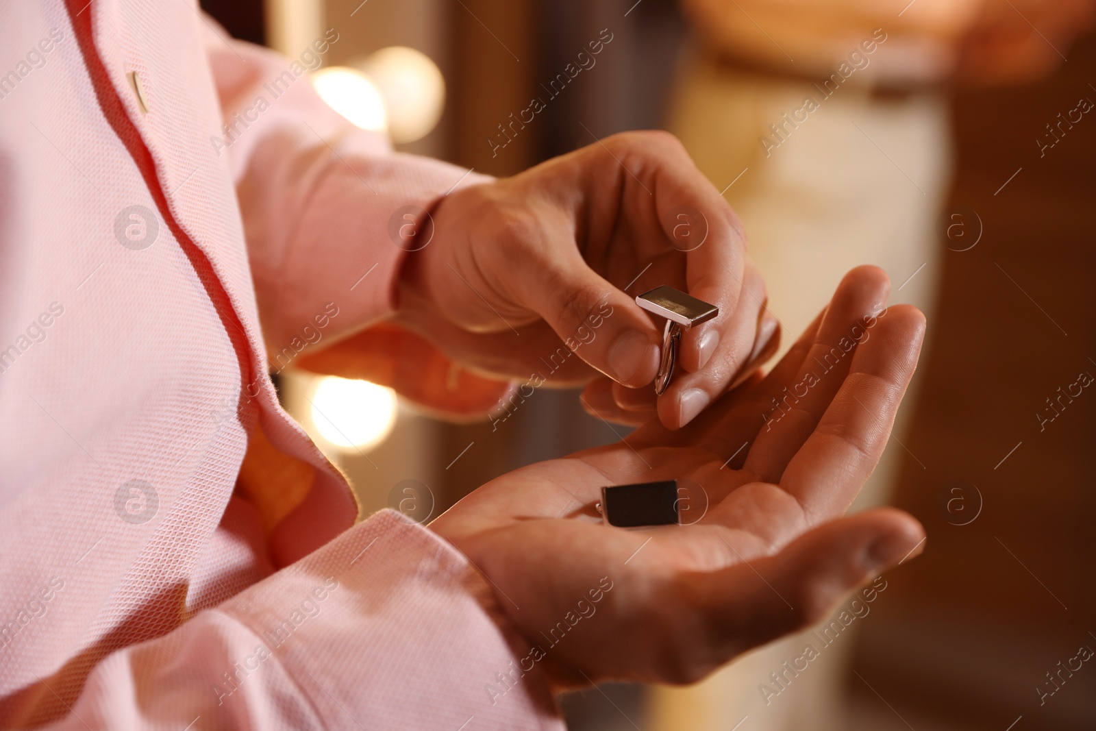Photo of Man with cufflinks getting ready indoors, closeup