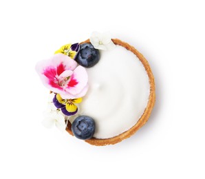 Photo of Delicious dessert. Tartlet with cream, berries and flowers isolated on white, top view