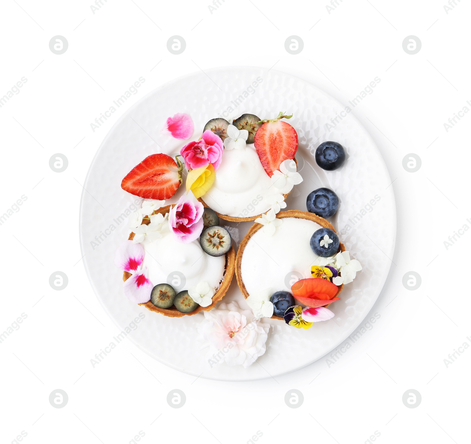 Delicious dessert. Tartlets with cream, berries and flowers isolated on white, top view Photo of Delicious dessert. Tartlets with cream, berries and flowers isolated on white, top view