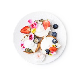 Photo of Delicious dessert. Tartlets with cream, berries and flowers isolated on white, top view