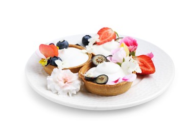 Photo of Delicious dessert. Tartlets with cream, berries and flowers isolated on white