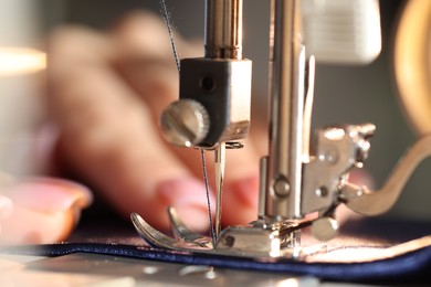 Photo of Woman working with sewing machine, macro view