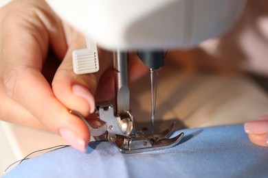 Photo of Woman working with sewing machine, macro view