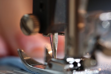 Photo of Sewing machine with thread and cloth, macro view