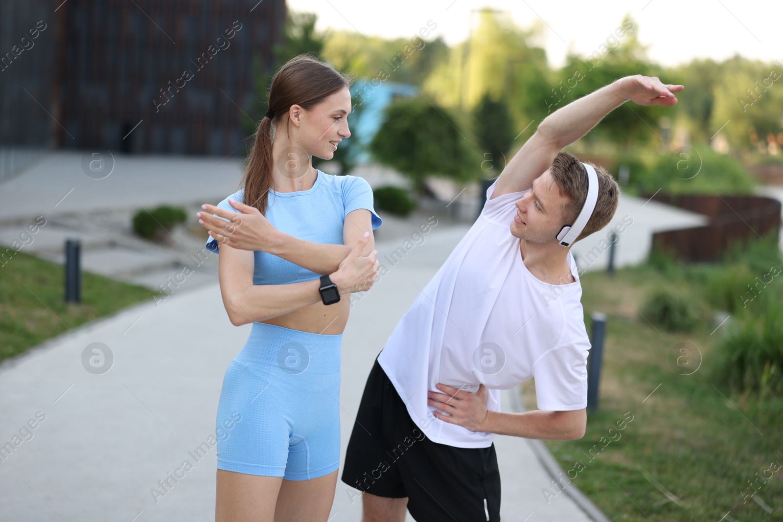 Happy couple doing morning exercises outdoors. Healthy lifestyle Photo of Happy couple doing morning exercises outdoors. Healthy lifestyle