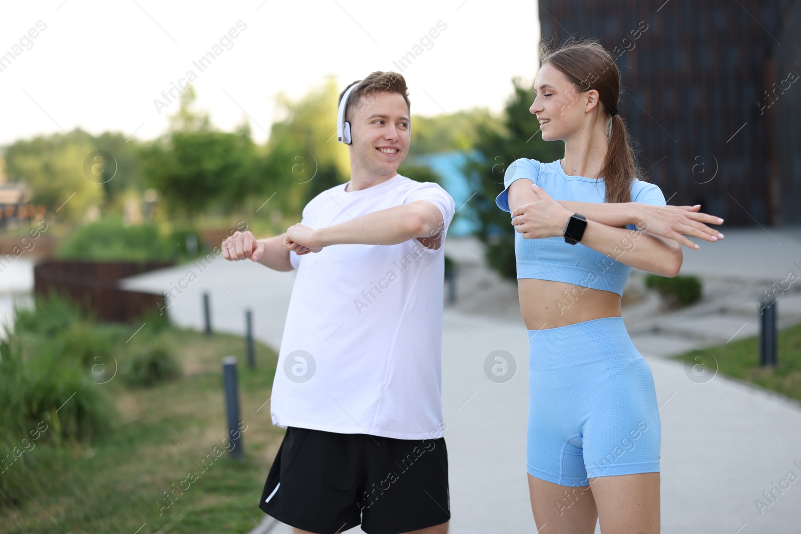 Happy couple doing morning exercises outdoors. Healthy lifestyle Photo of Happy couple doing morning exercises outdoors. Healthy lifestyle