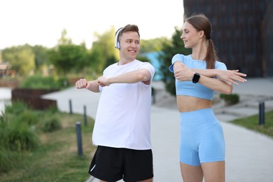 Photo of Happy couple doing morning exercises outdoors. Healthy lifestyle