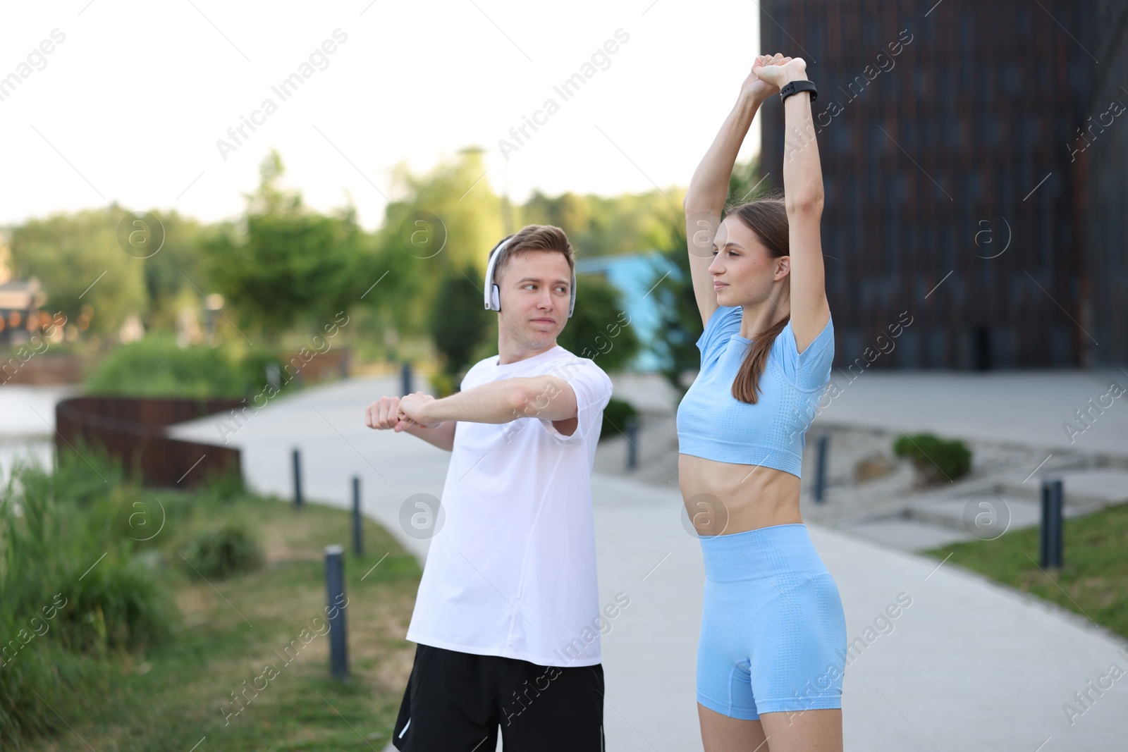 Couple doing morning exercises outdoors. Healthy lifestyle Photo of Couple doing morning exercises outdoors. Healthy lifestyle