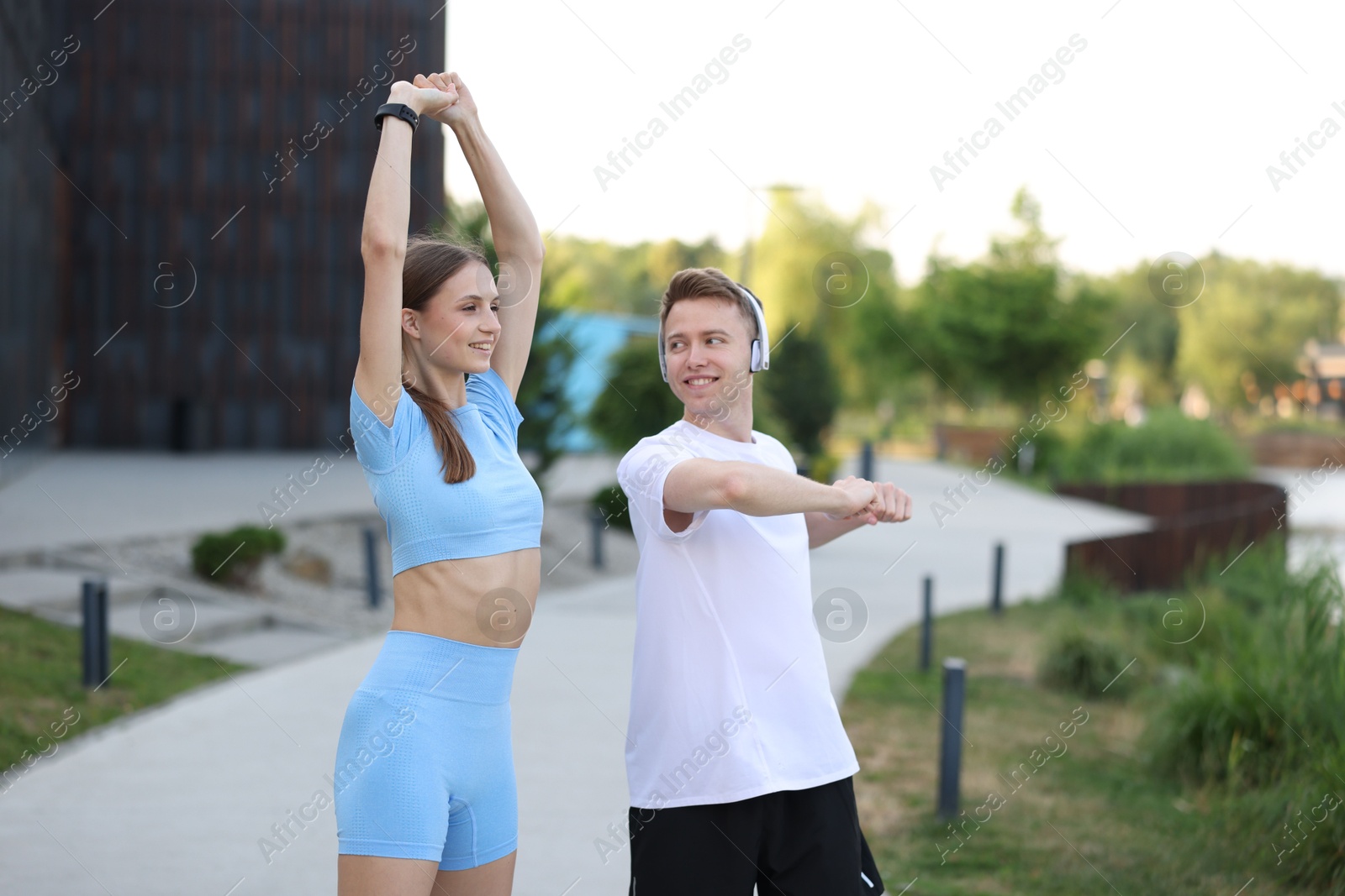 Happy couple doing morning exercises outdoors. Healthy lifestyle Photo of Happy couple doing morning exercises outdoors. Healthy lifestyle