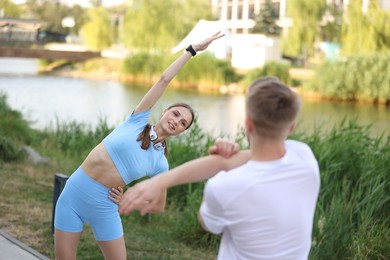 Photo of Couple doing morning exercises outdoors. Healthy lifestyle