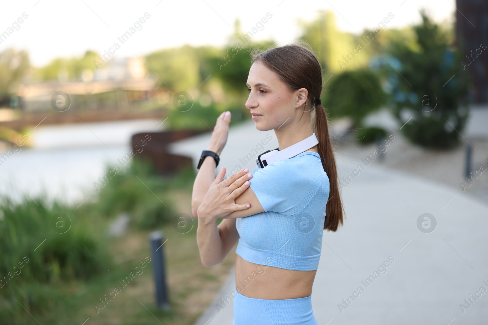 Young sportswoman doing morning exercise outdoors. Healthy lifestyle Photo of Young sportswoman doing morning exercise outdoors. Healthy lifestyle