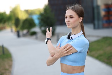 Photo of Young sportswoman doing morning exercise outdoors. Healthy lifestyle