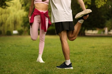 Photo of Couple doing morning exercise in park, closeup