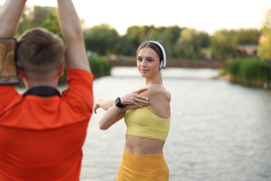 Photo of Couple doing morning exercise near beautiful river