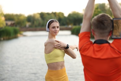 Photo of Couple doing morning exercise near beautiful river