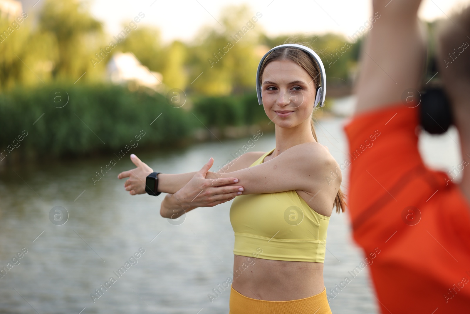 Photo of Couple doing morning exercise near river, closeup