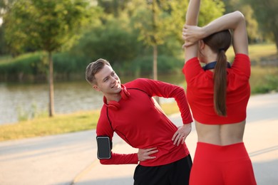 Photo of Happy couple doing morning exercise outdoors. Healthy lifestyle