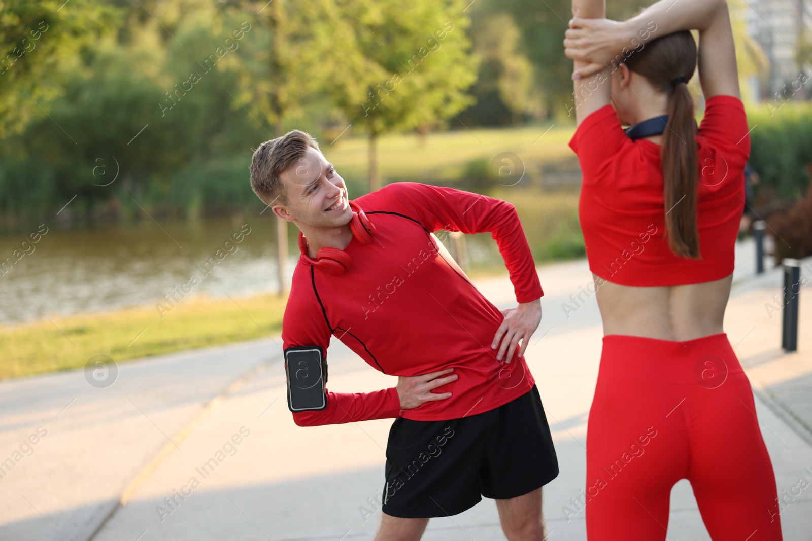 Happy couple doing morning exercise outdoors. Healthy lifestyle Photo of Happy couple doing morning exercise outdoors. Healthy lifestyle