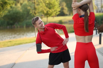 Photo of Happy couple doing morning exercise outdoors. Healthy lifestyle