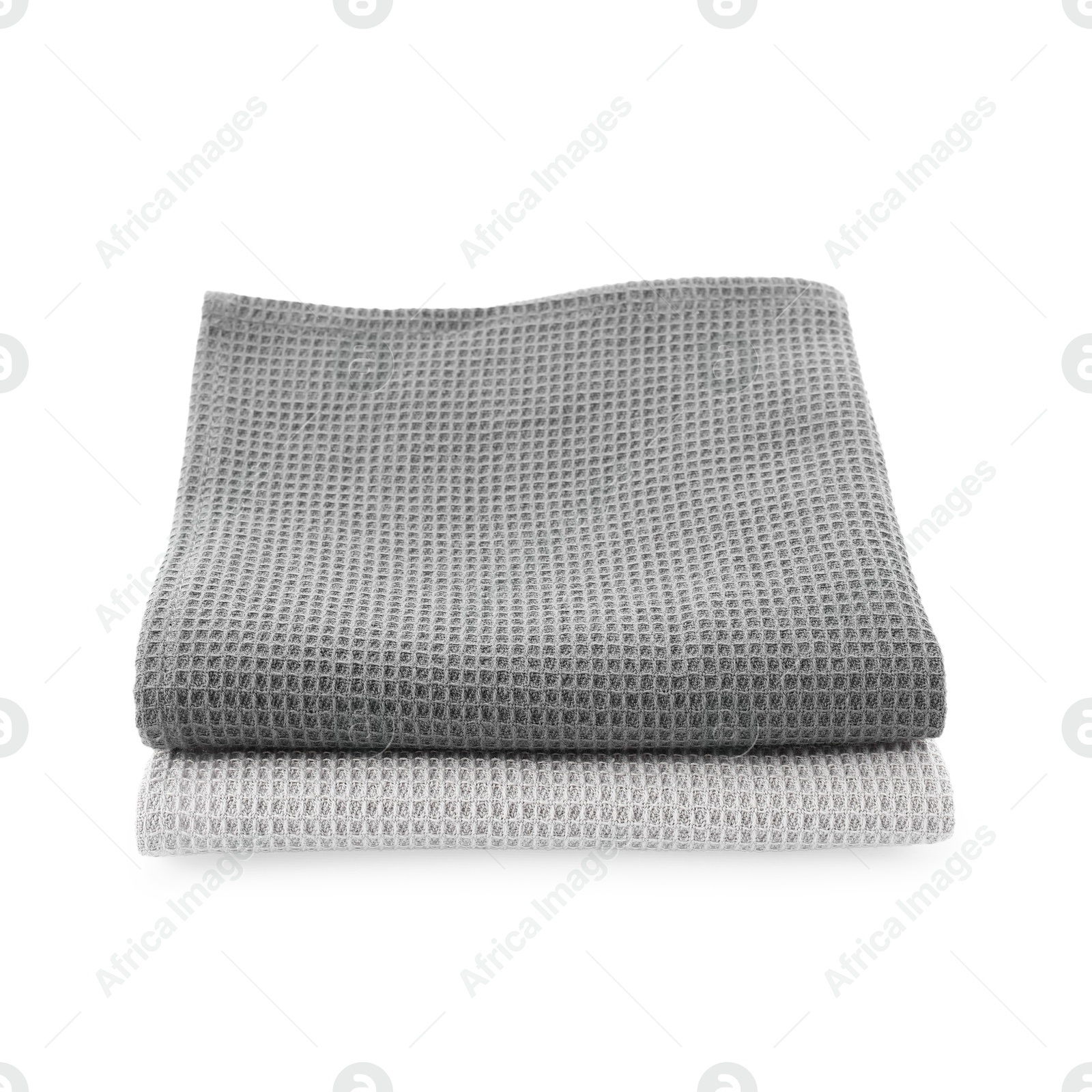 Photo of Clean stacked waffle towels isolated on white