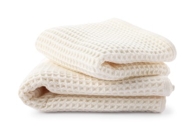 Photo of Clean stacked waffle towels isolated on white