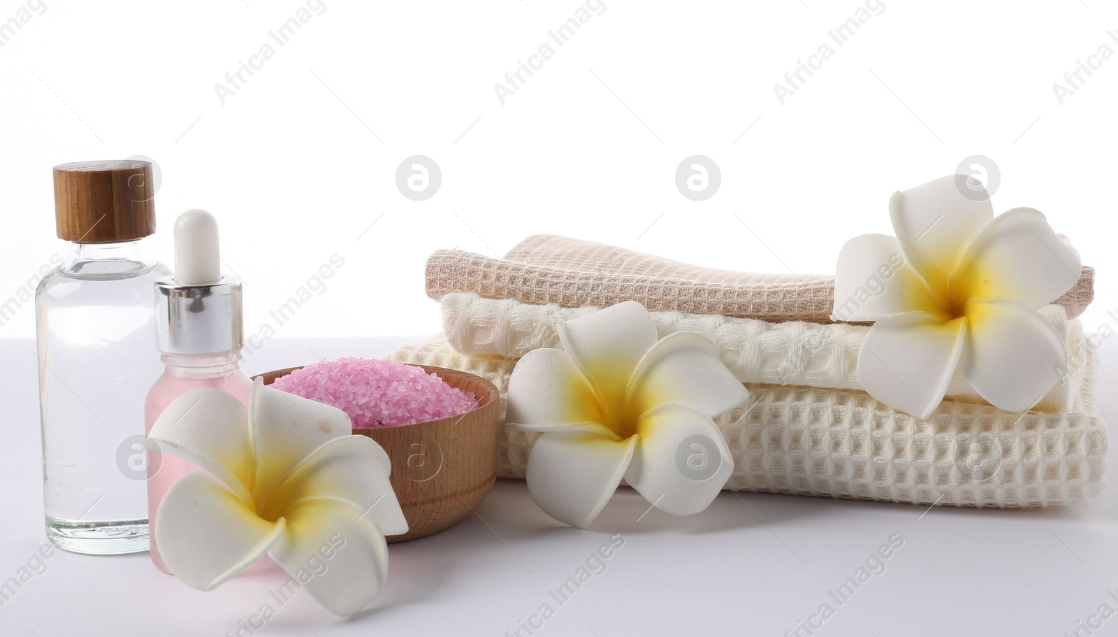 Photo of Spa composition with waffle towels and cosmetic products isolated on white