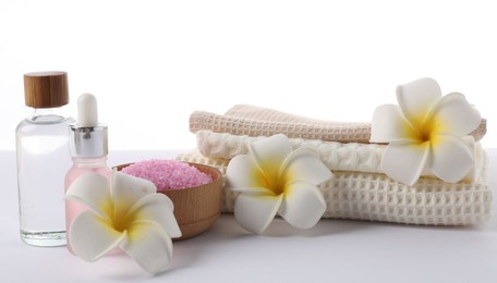 Photo of Spa composition with waffle towels and cosmetic products isolated on white