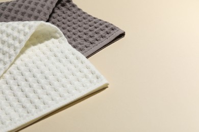 Photo of Clean waffle towels on beige background, closeup. Space for text