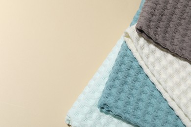 Photo of Clean waffle towels on beige background, top view. Space for text