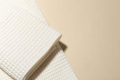 Photo of Clean waffle towels on beige background, top view. Space for text