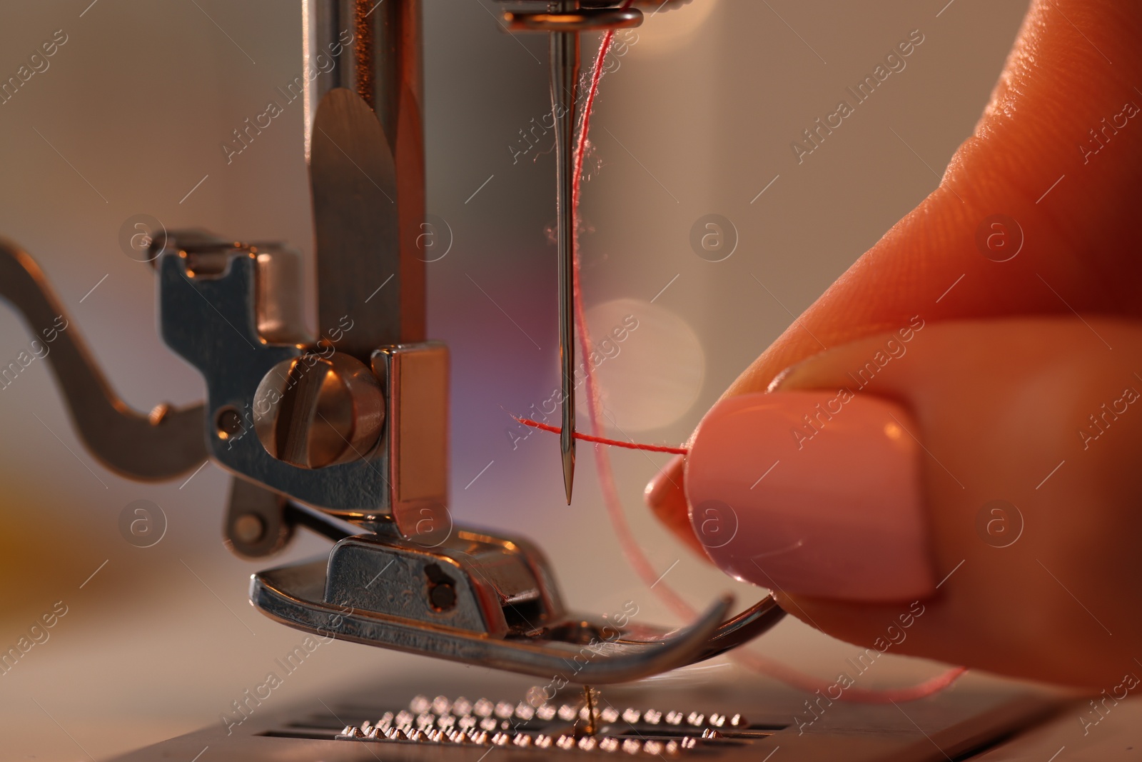 Woman working with sewing machine in workshop, closeup Photo of Woman working with sewing machine in workshop, closeup
