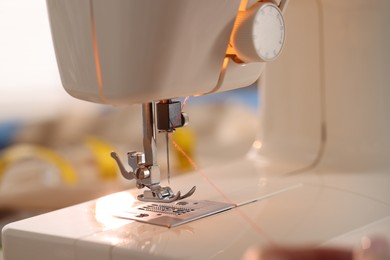 Photo of Closeup view of sewing machine with thread