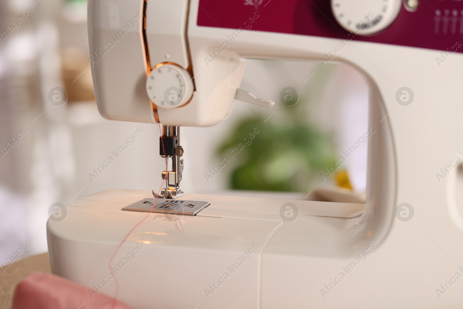 Closeup view of sewing machine with thread Photo of Closeup view of sewing machine with thread