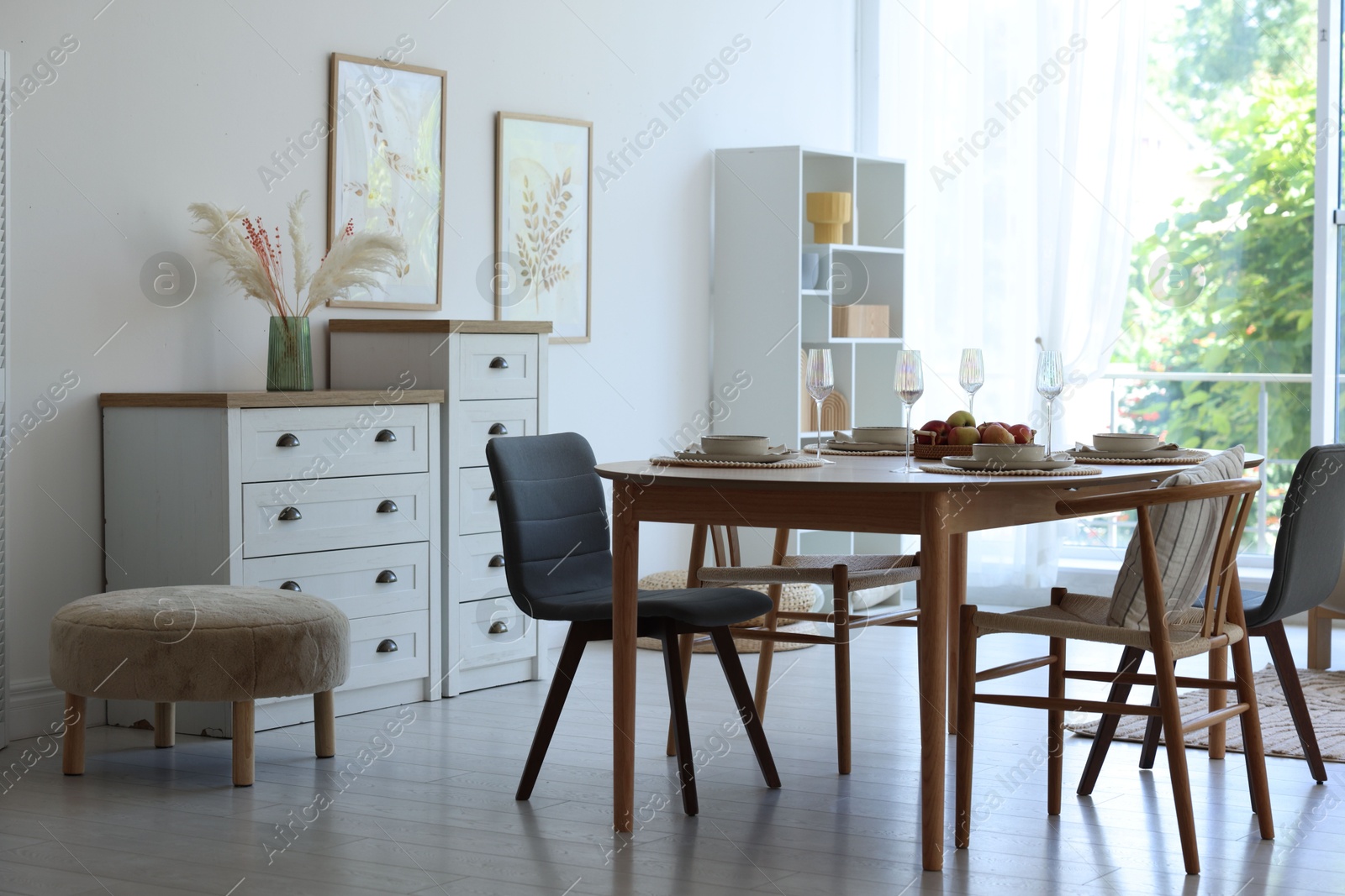 Beautiful table setting, chairs and decor in dining room. Interior design Photo of Beautiful table setting, chairs and decor in dining room. Interior design