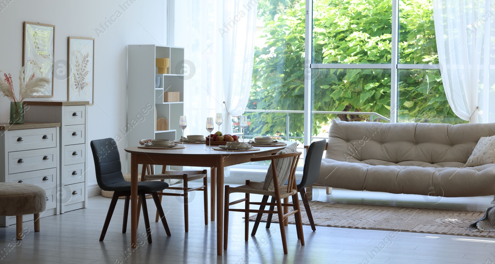 Beautiful table setting, chairs and decor in dining room. Interior design Photo of Beautiful table setting, chairs and decor in dining room. Interior design