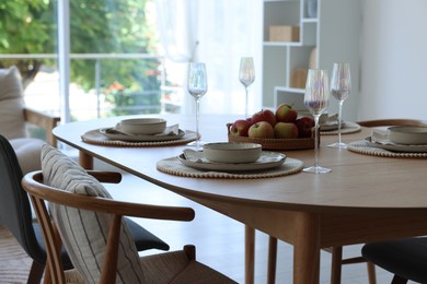 Photo of Beautiful table setting, chairs and decor in dining room. Interior design