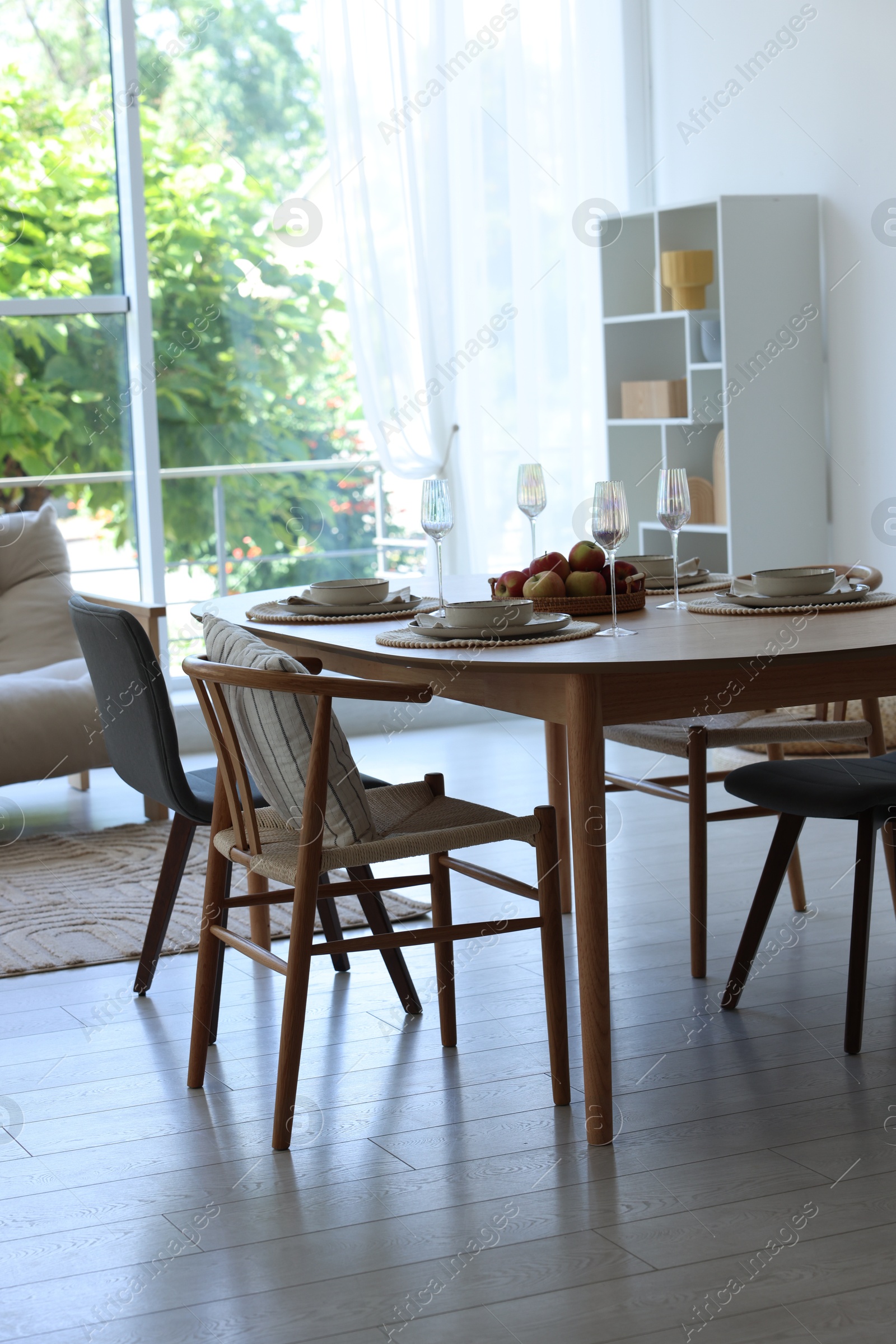Beautiful table setting, chairs and decor in dining room. Interior design Photo of Beautiful table setting, chairs and decor in dining room. Interior design