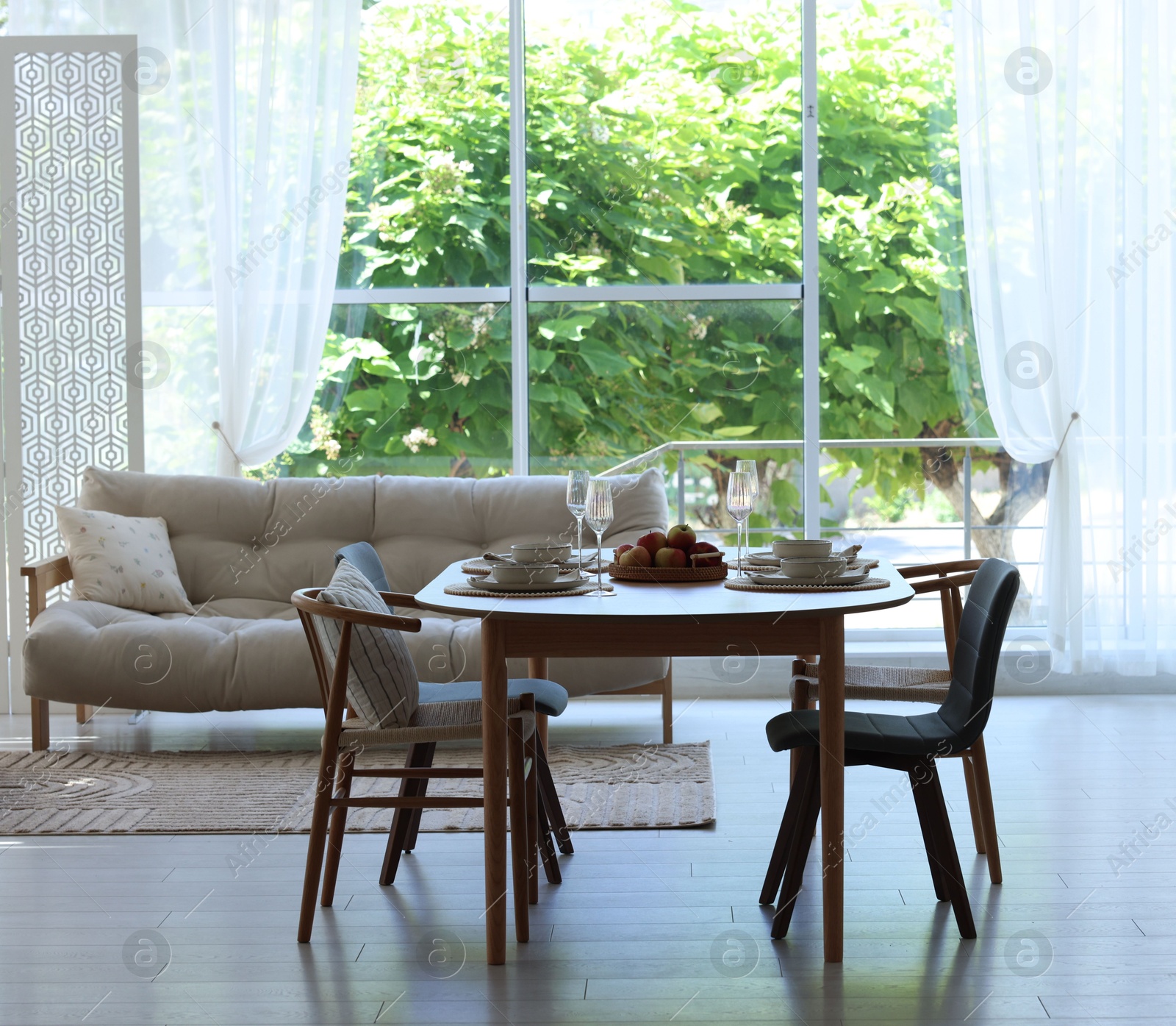 Beautiful table setting, chairs and decor in dining room. Interior design Photo of Beautiful table setting, chairs and decor in dining room. Interior design