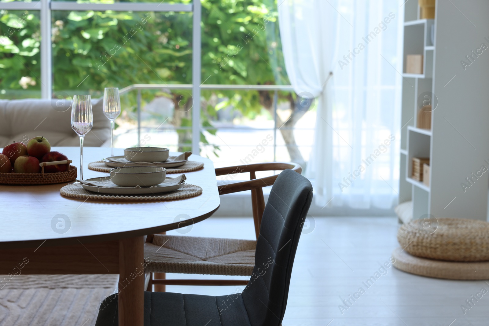 Beautiful table setting, chairs and decor in dining room. Interior design Photo of Beautiful table setting, chairs and decor in dining room. Interior design