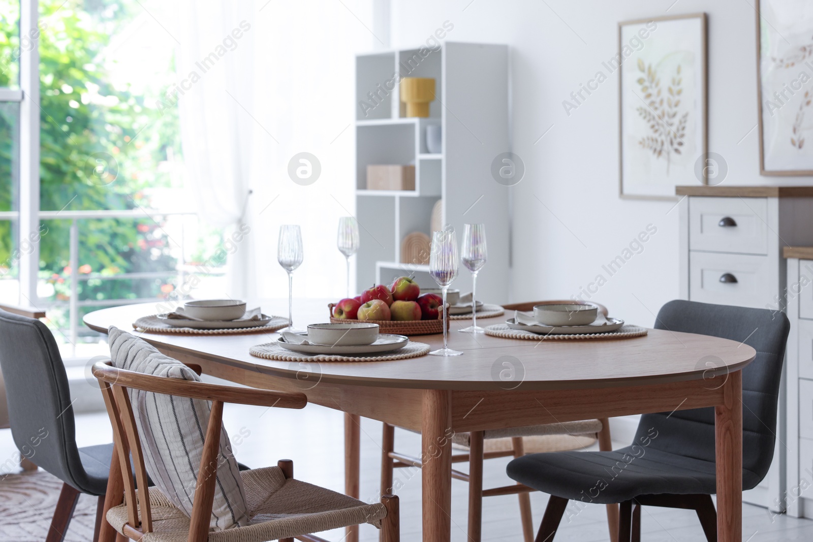 Beautiful table setting, chairs and decor in dining room. Interior design Photo of Beautiful table setting, chairs and decor in dining room. Interior design