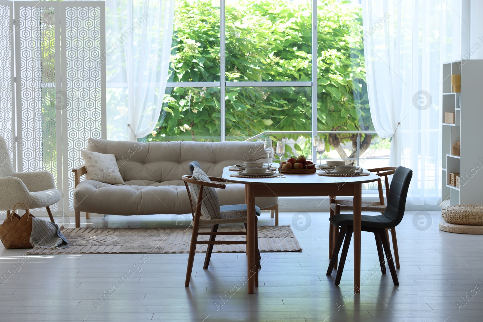Beautiful table setting, chairs and decor in dining room. Interior design Photo of Beautiful table setting, chairs and decor in dining room. Interior design