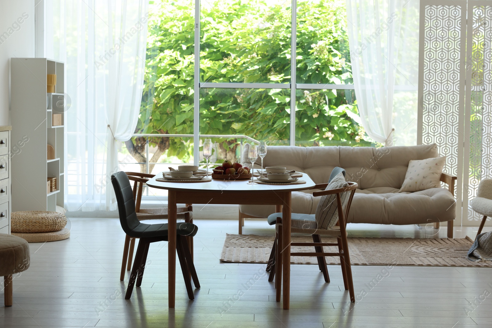Beautiful table setting, chairs and decor in dining room. Interior design Photo of Beautiful table setting, chairs and decor in dining room. Interior design
