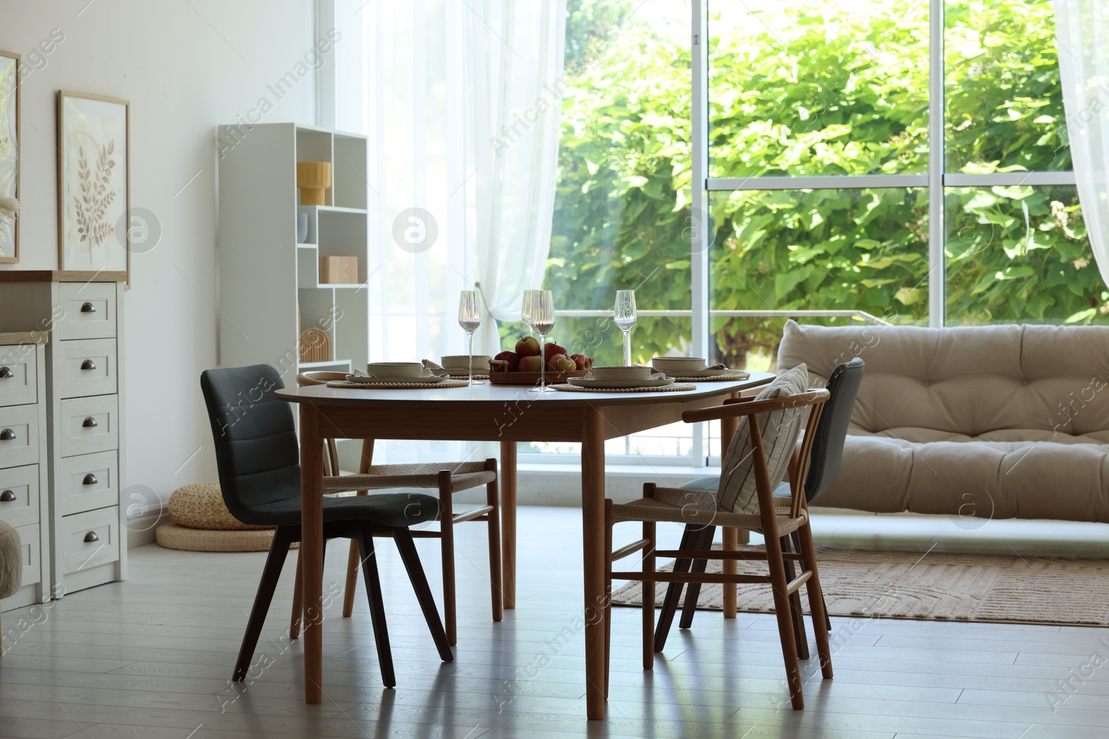 Beautiful table setting, chairs and decor in dining room. Interior design Photo of Beautiful table setting, chairs and decor in dining room. Interior design