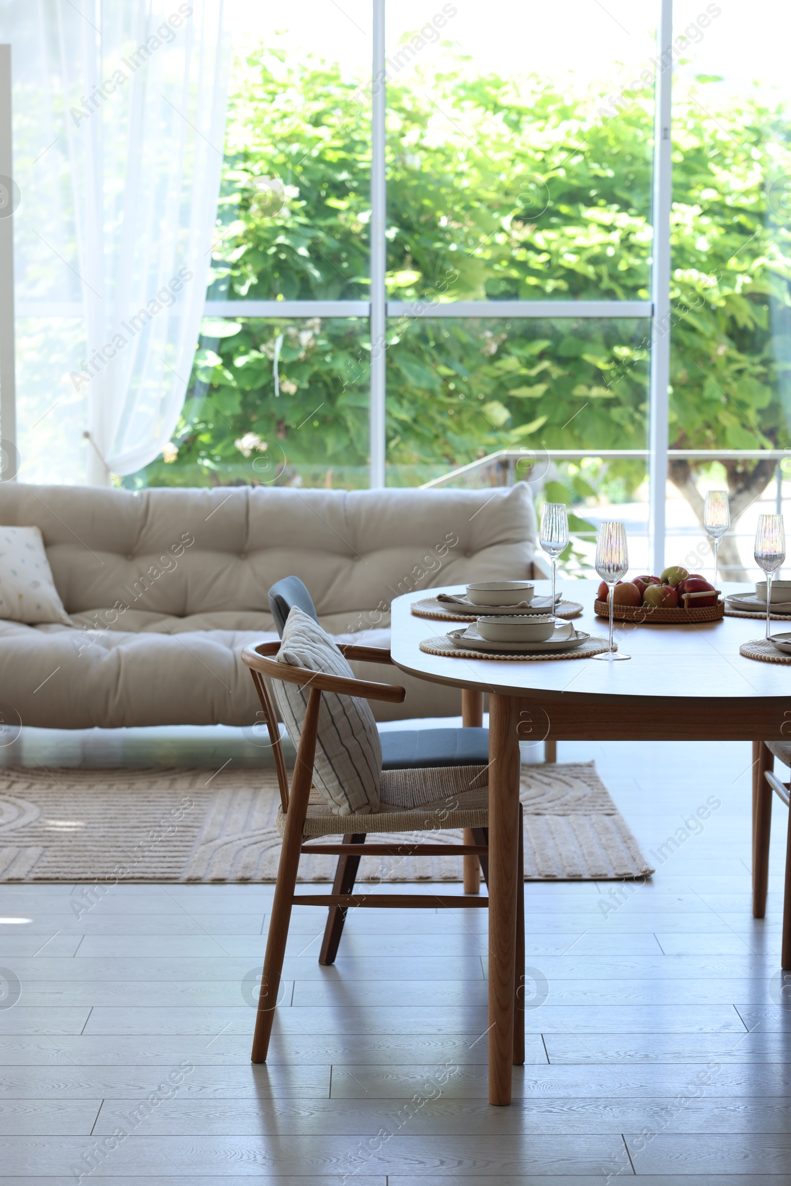 Beautiful table setting, chairs and decor in dining room. Interior design Photo of Beautiful table setting, chairs and decor in dining room. Interior design