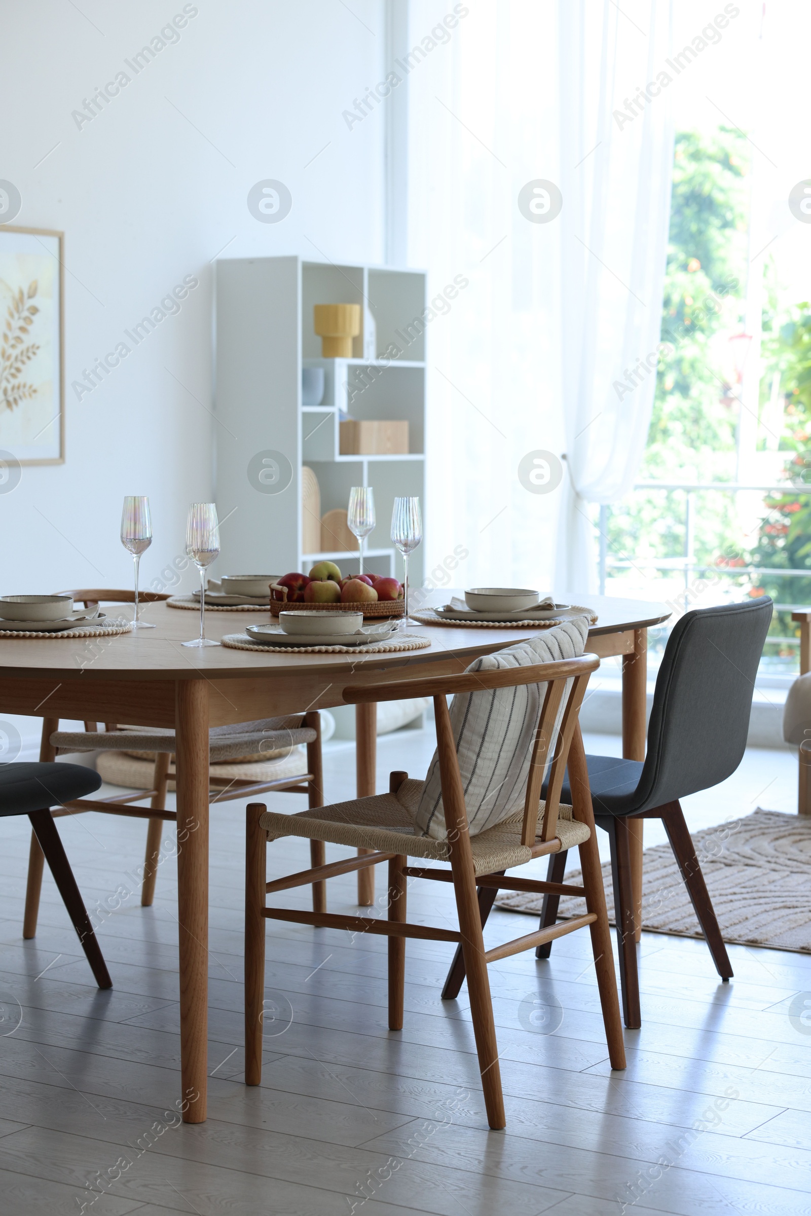 Beautiful table setting, chairs and decor in dining room. Interior design Photo of Beautiful table setting, chairs and decor in dining room. Interior design