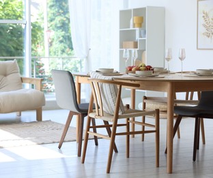 Photo of Beautiful table setting, chairs and decor in dining room. Interior design