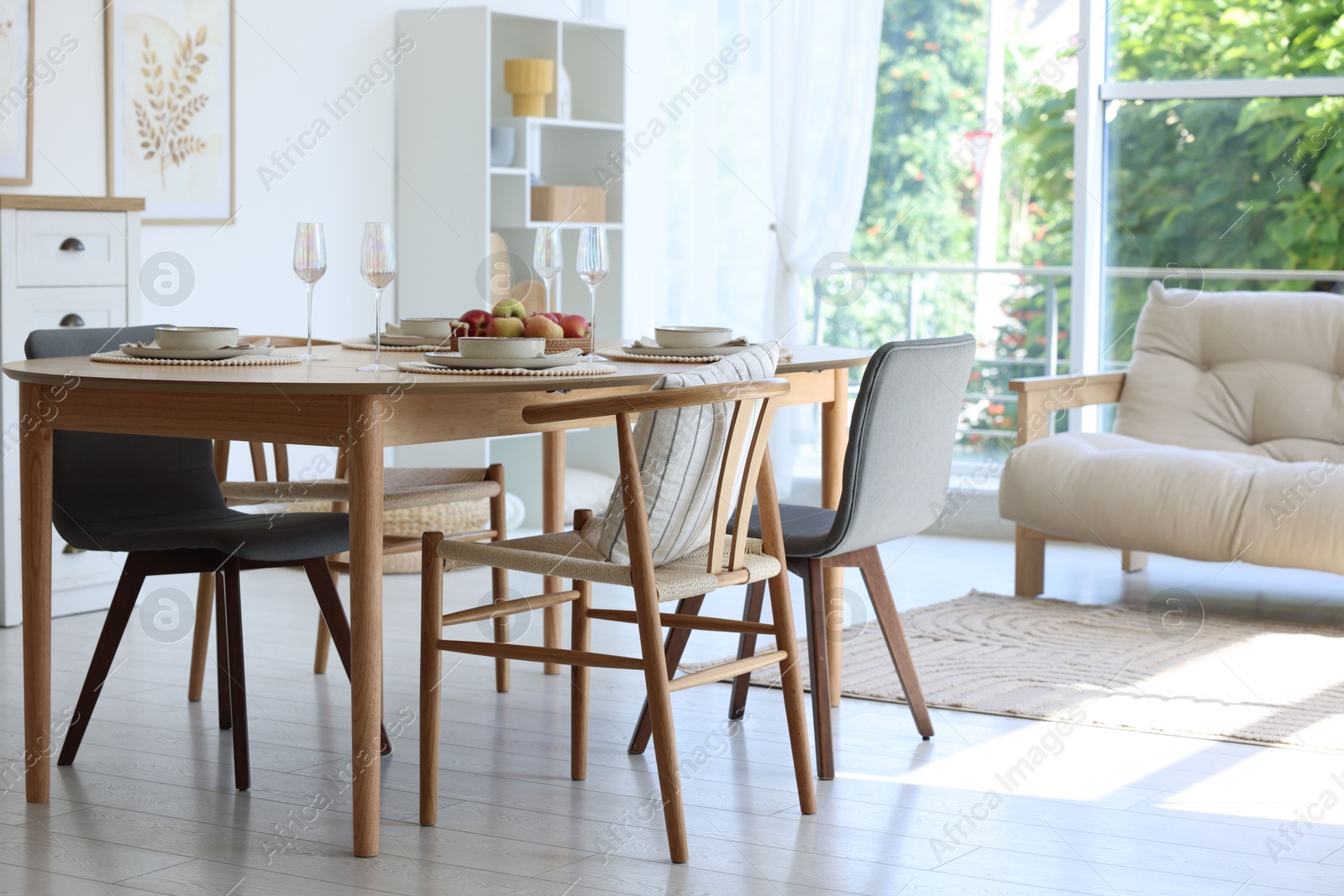 Beautiful table setting, chairs and decor in dining room. Interior design Photo of Beautiful table setting, chairs and decor in dining room. Interior design