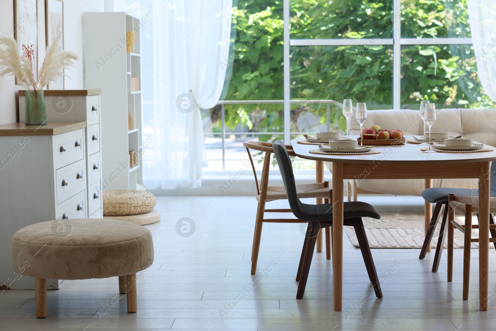 Beautiful table setting, chairs and decor in dining room. Interior design Photo of Beautiful table setting, chairs and decor in dining room. Interior design
